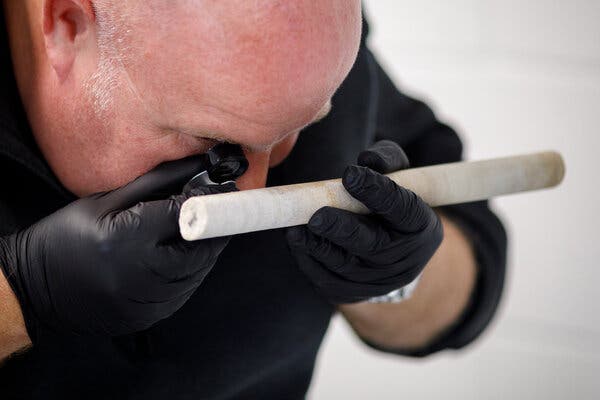 David Nash, a geomorphologist at University of Brighton, examining a core from Stone 58 that was stolen in the 1950s and was recently repatriated.