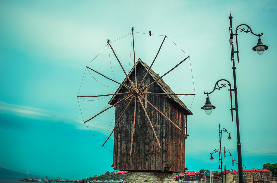 A small wooden windmill against turquoise skies in Nessebar, Sunny Beach, Bulgaria