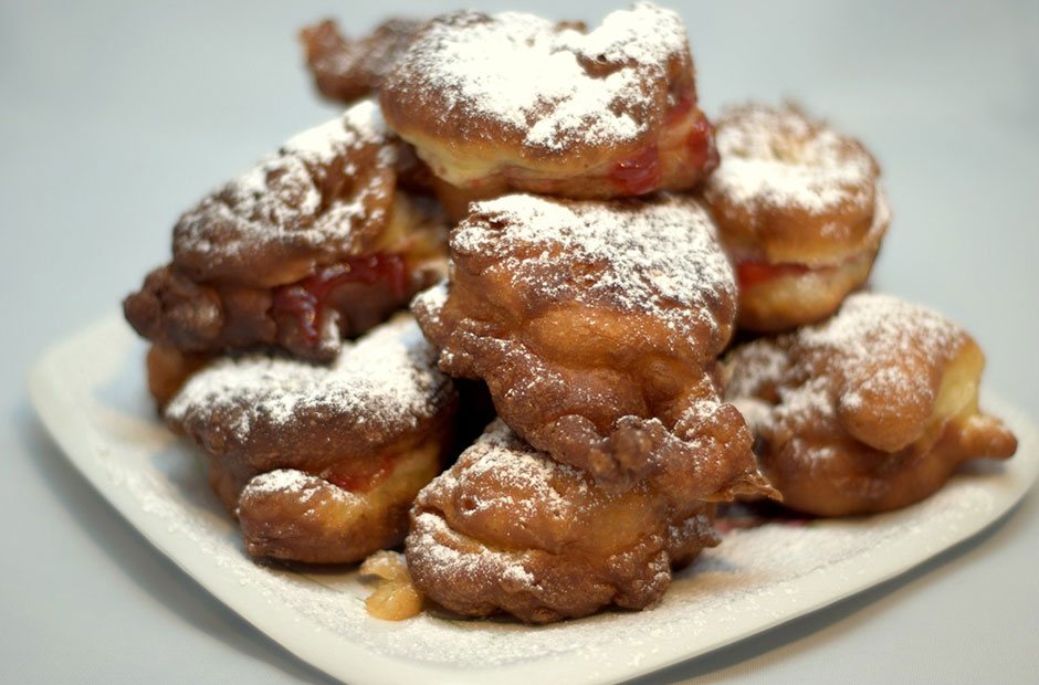 Bulgarian pastries on a plate topped with powdered sugar